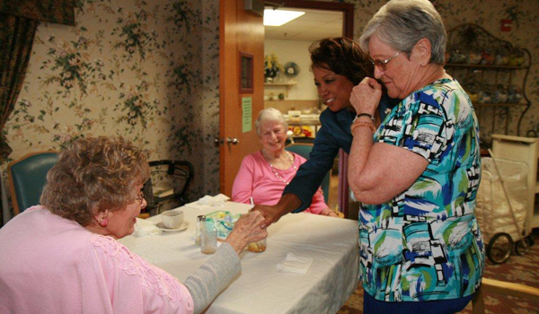 Jennifer visits with seniors at Advent Christian Retirement Center