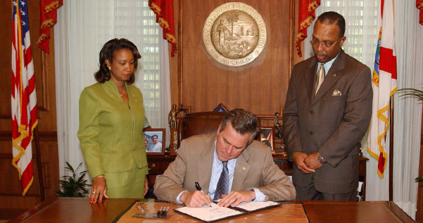 Jennifer's first bill passed as a legislator, Neighborhood Watch Program, Session 2004 Bill Signing with Gov Bush and Senator Miller
